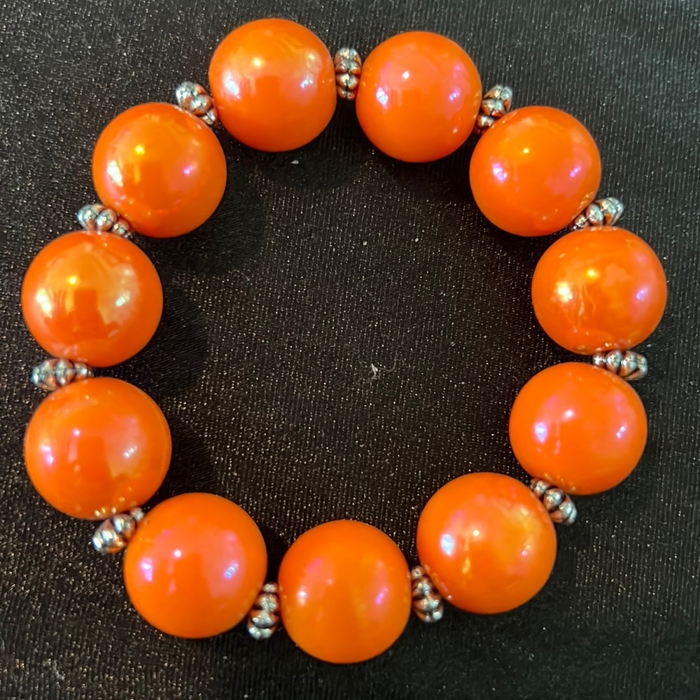 Garold Miller stretch bracelet with silver separators. Incandescent orange